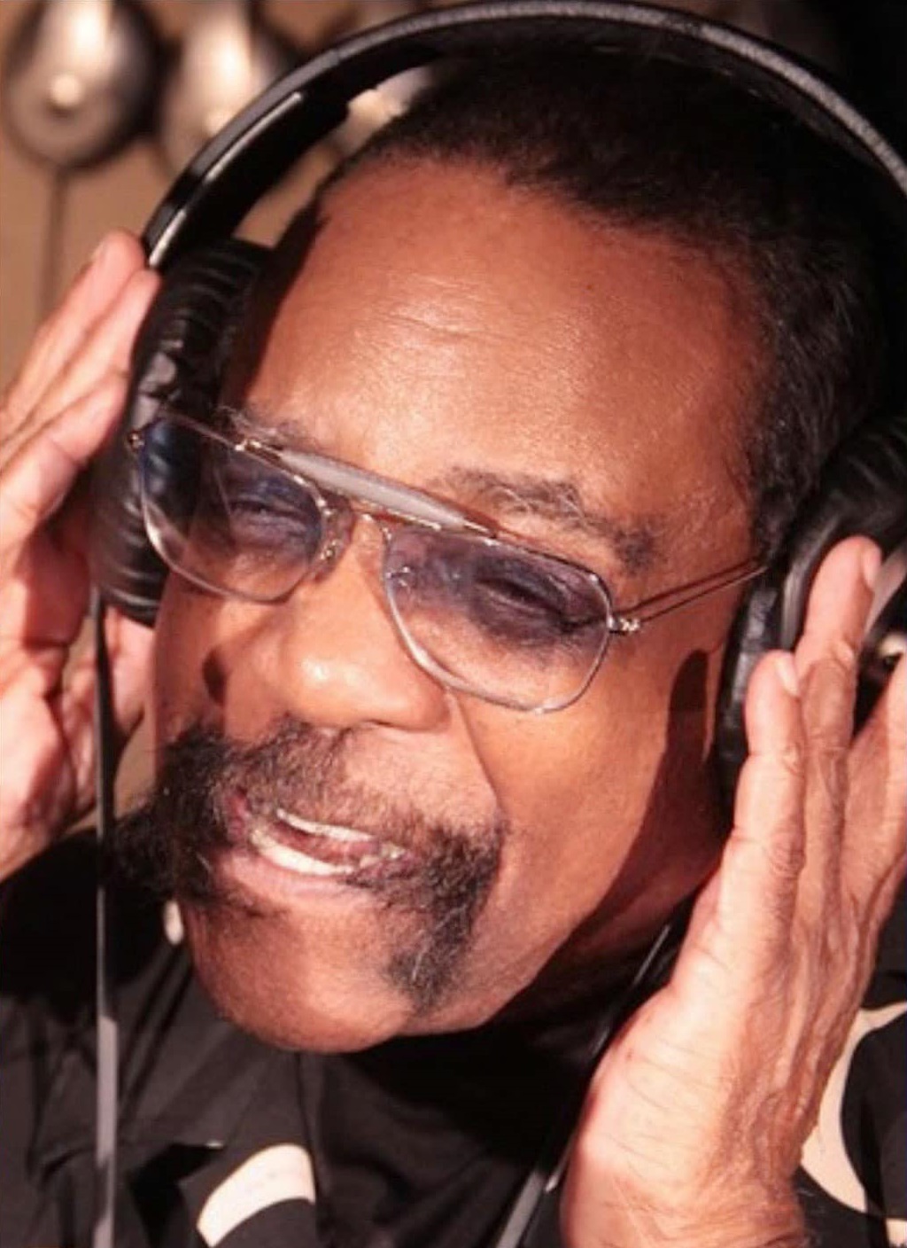 Portrait of Frankie Smith smiling in a light shirt.